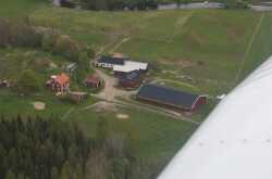Flygfoto över Västanbytorp med Svartån i övre kanten. - klicka för att förstora